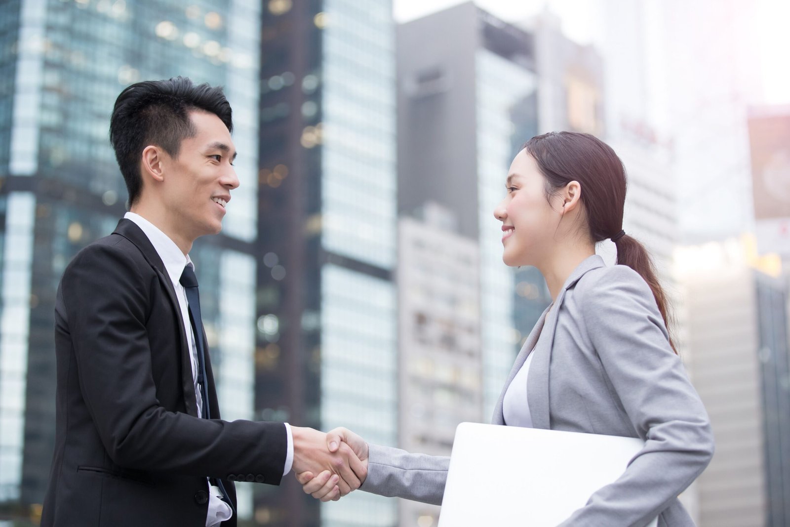 An Owee Commercial property agent in tenant representation handshake with a client 